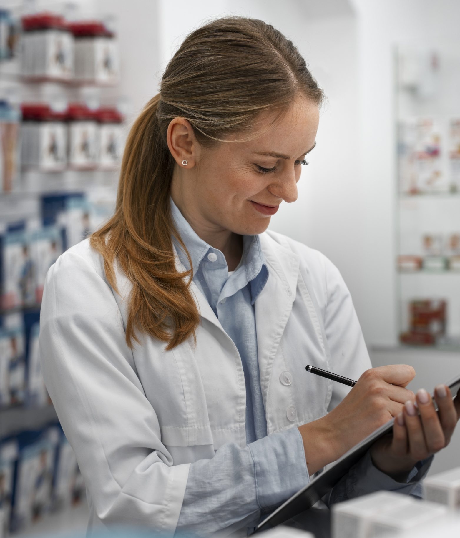 female-pharmacist-checking-medicine-with-clipboard-scaled (1)